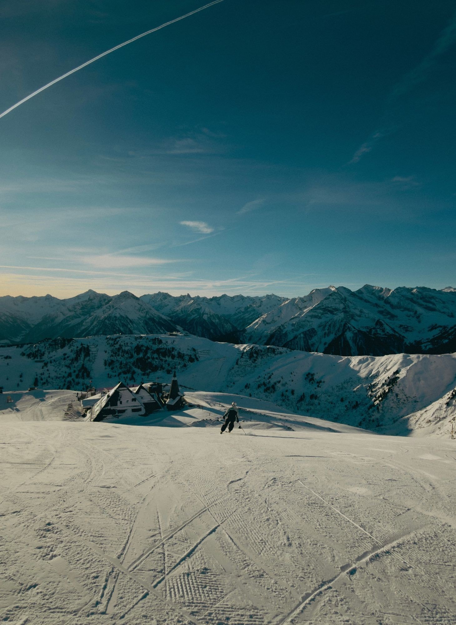Skiing a groomed run above the valley